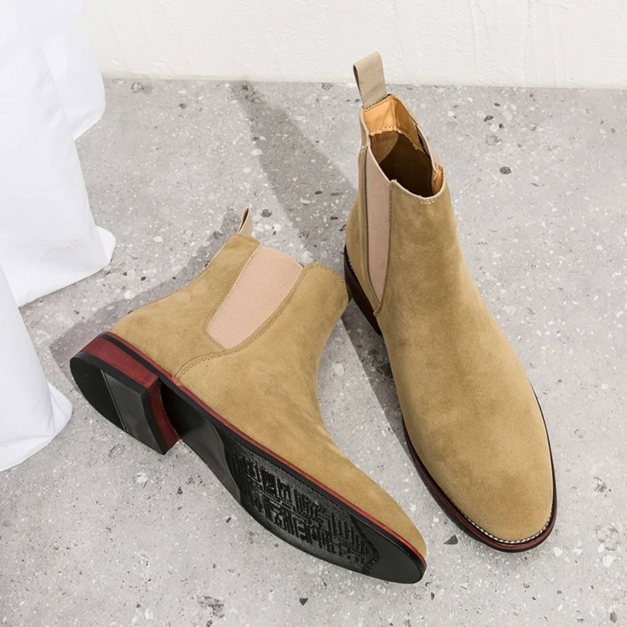 FORCIANO IVORY beige suede elevator boots shown from an angled view with one outsole and heel visible.