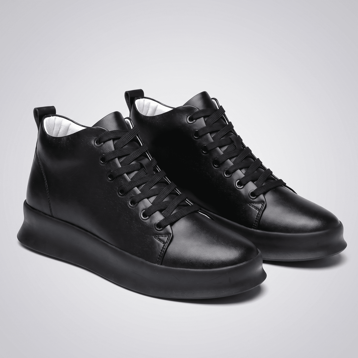 Pair of black FORCIANO ACHILLES Height Boosting Sneakers shown from a front three-quarter angle.