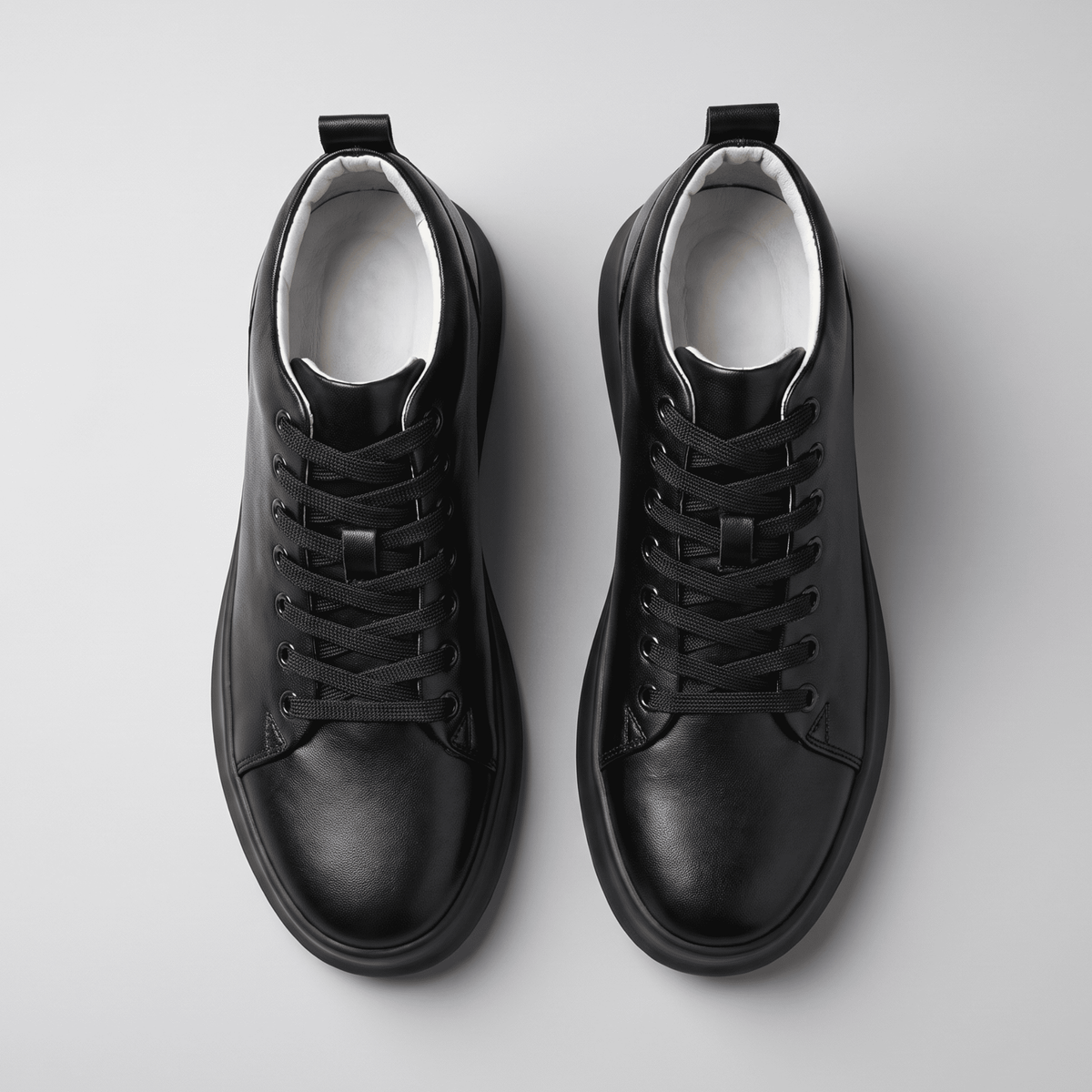 Pair of black FORCIANO ACHILLES Height Boosting Sneakers photographed from the top with laces and interiors visible.