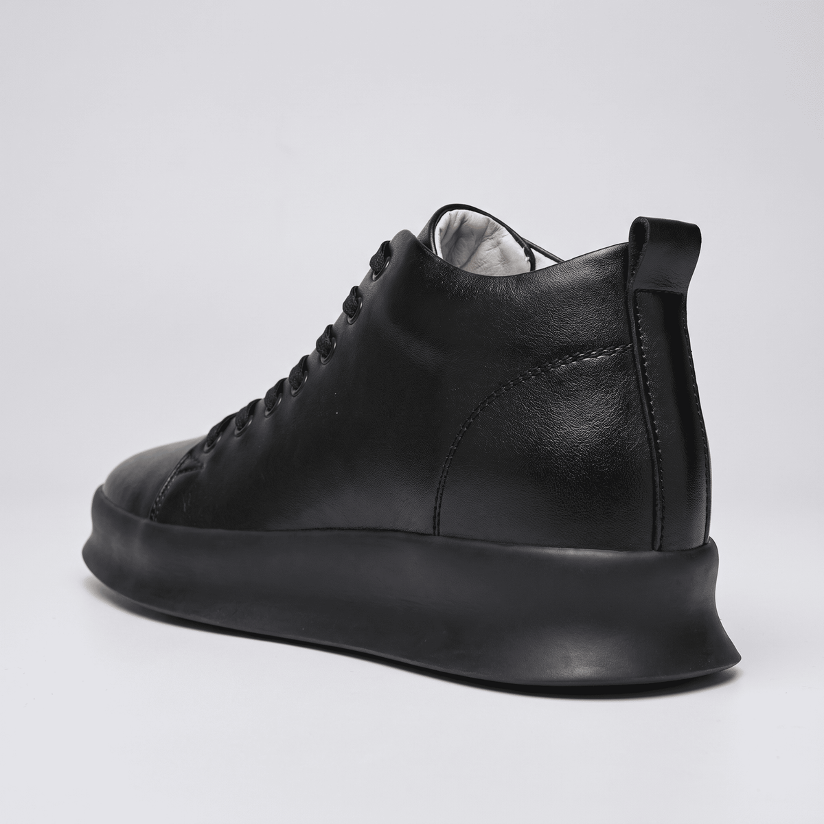Black FORCIANO ACHILLES Height Boosting Sneakers shown from a rear three-quarter angle with heel detail visible.