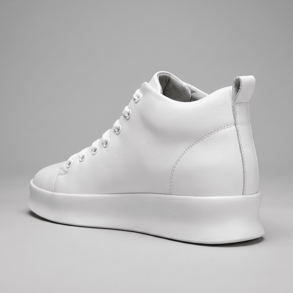 White FORCIANO ACHILLES Height Boosting Sneakers shown from a rear three-quarter view with heel detail.