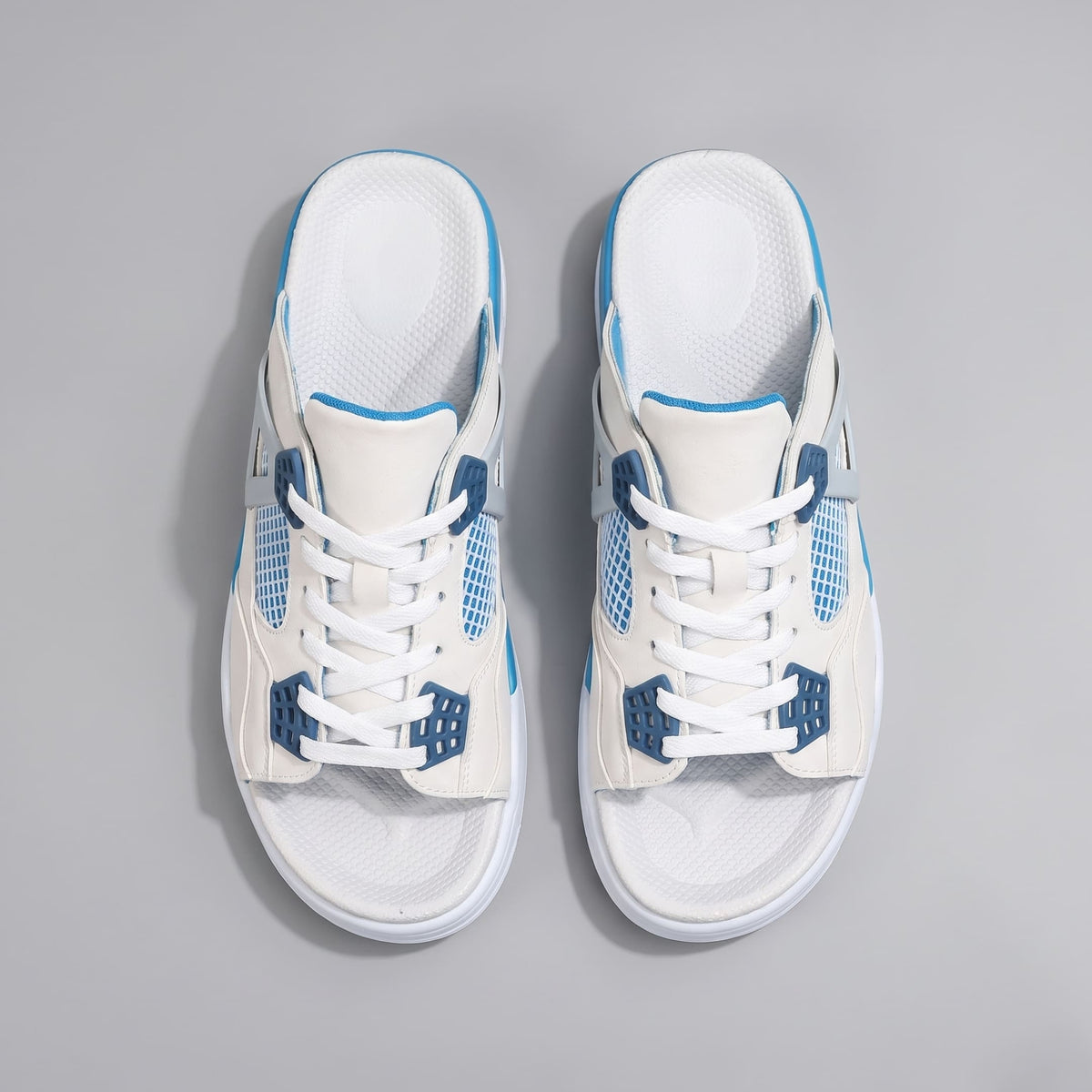 Pair of white and blue FORCIANO AERO Height Increasing Slippers shown from the top with white laces and blue accents.
