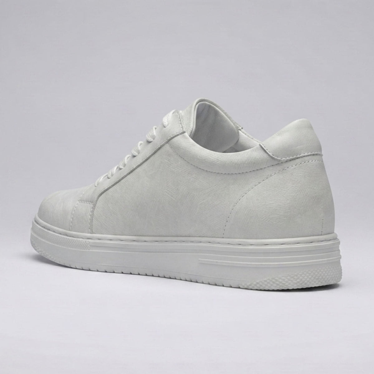 FORCIANO ATHENA white women's elevator sneaker shown from the rear three-quarter angle, featuring a premium leather upper, heel stitching and white sole.