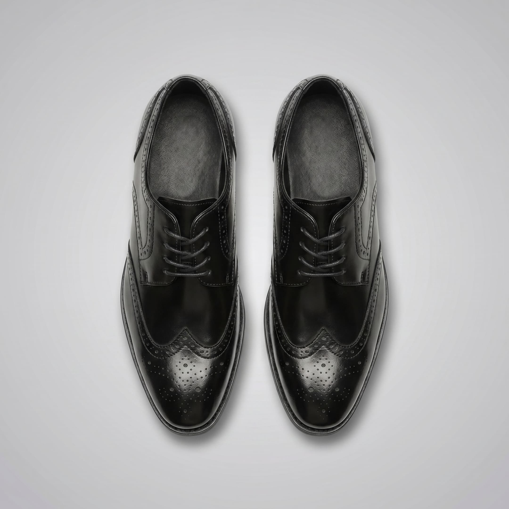 FORCIANO BROGUE black premium leather elevator dress shoes shown from above as a pair with lace-up fronts and brogue perforations.