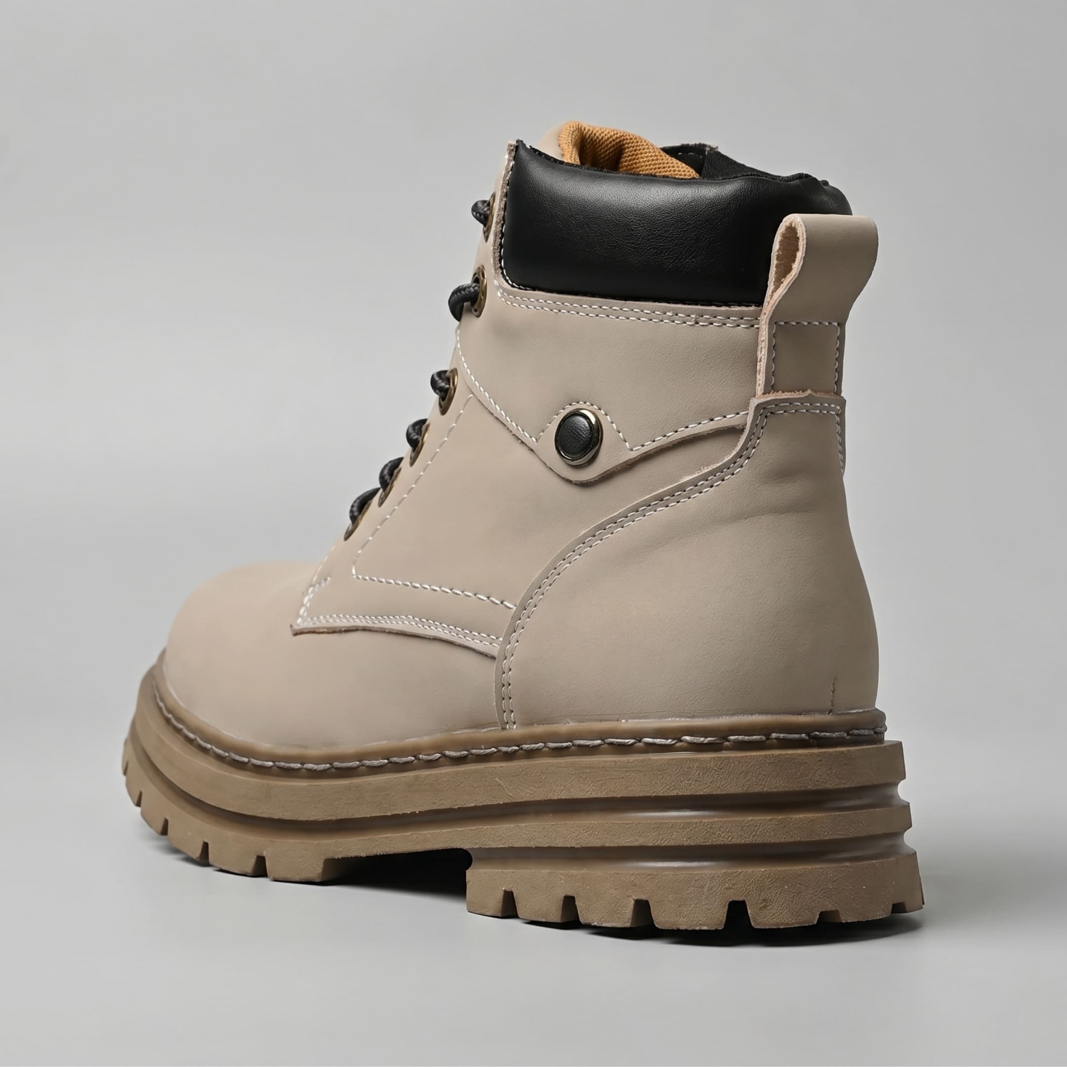FORCIANO CALIBER grey elevator boot with premium suede upper shown from a rear three-quarter angle with stitching, heel loop and sole visible.