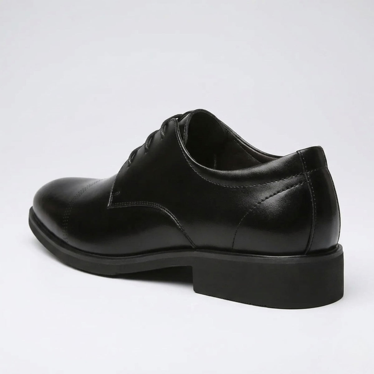 Rear three-quarter view of a FORCIANO CAVELLO black elevator dress shoe with premium leather upper showing the heel construction and side profile.