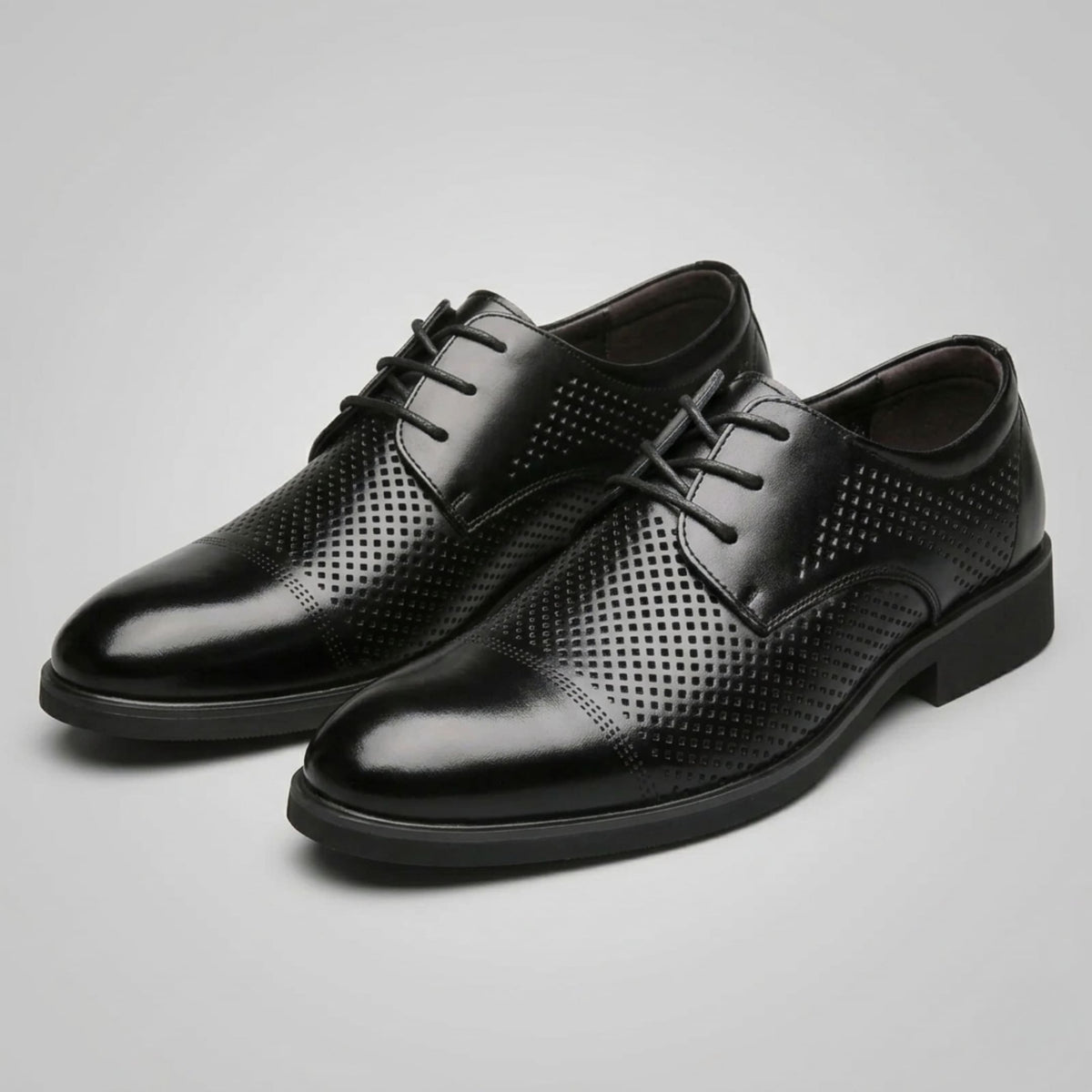 Pair of FORCIANO CAVELLO black perforated elevator dress shoes with premium leather uppers displayed from a front three-quarter angle.