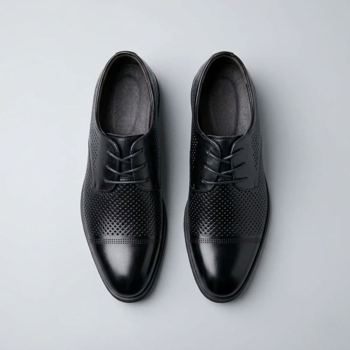 Top view of FORCIANO CAVELLO black perforated elevator dress shoes with premium leather uppers and patterned perforations across the vamp.