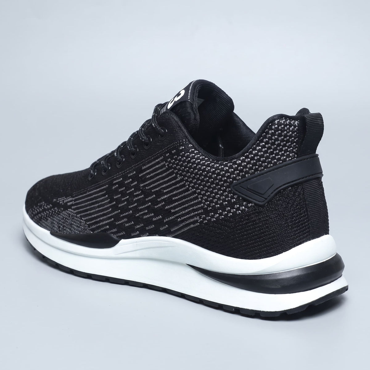 FORCIANO EDGE black Height Increasing Sneakers shown from a rear three-quarter angle with a white sole and breathable material for extended wear.