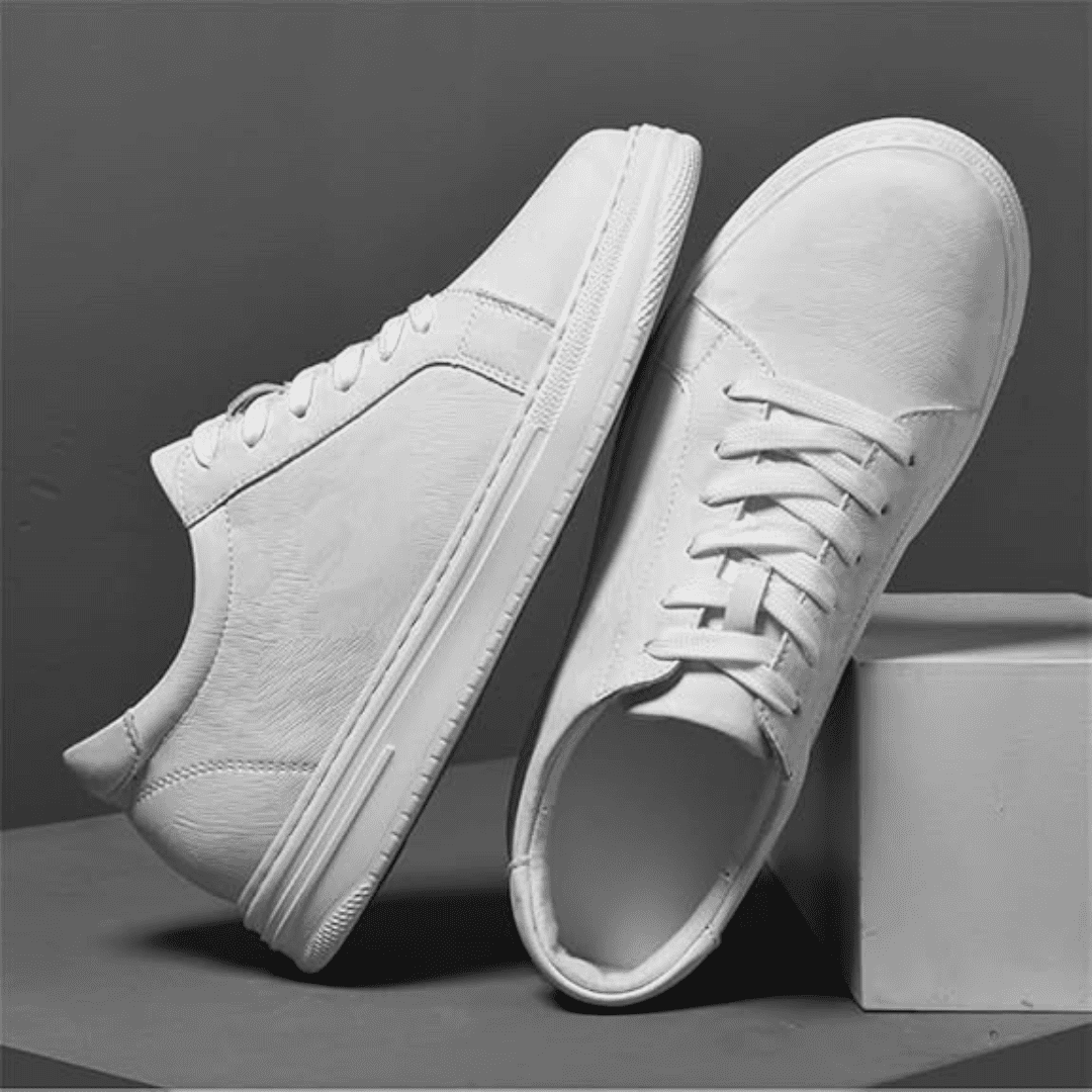 Pair of FORCIANO ELEMENT white premium leather sneakers arranged in side and top views on a gray studio display.