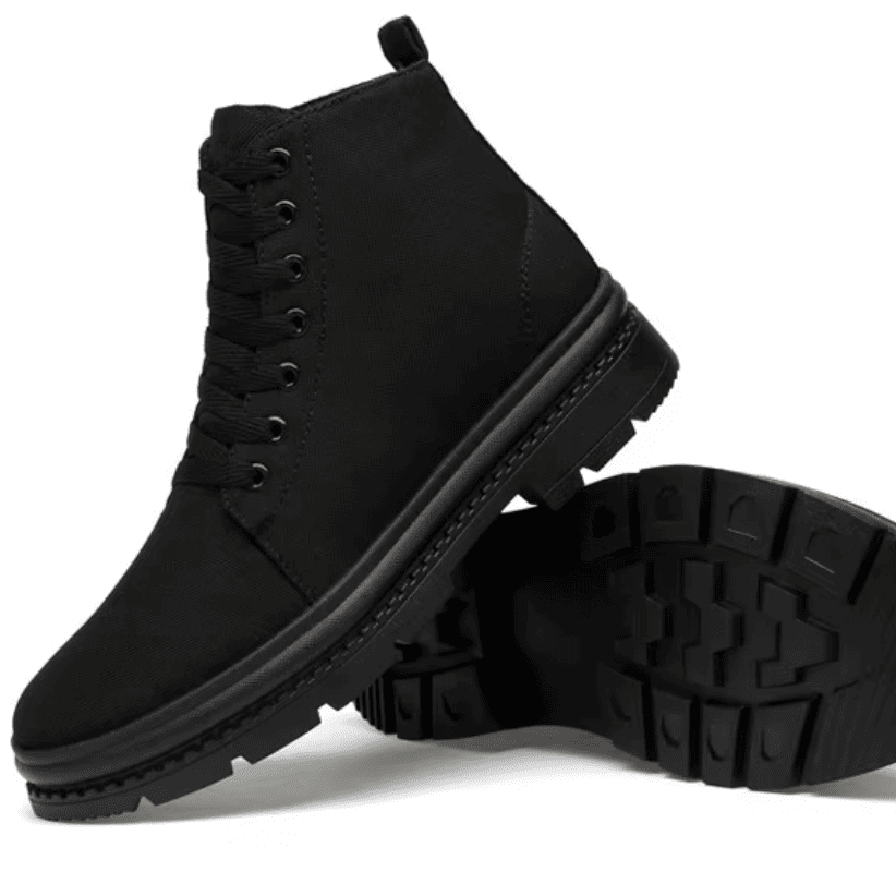 FORCIANO FORTITUDE black elevator boots displayed with one boot upright and the second showing the black treaded outsole.