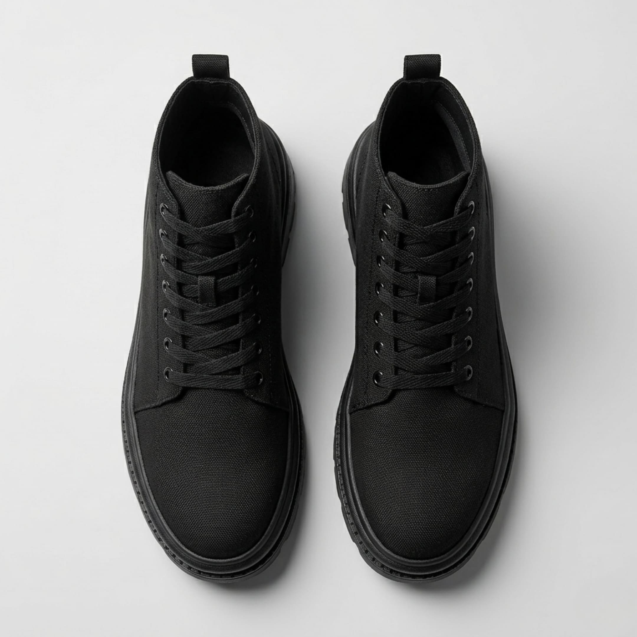Pair of FORCIANO FORTITUDE black elevator boots shown from the top, highlighting the laces, openings and rounded toe design.