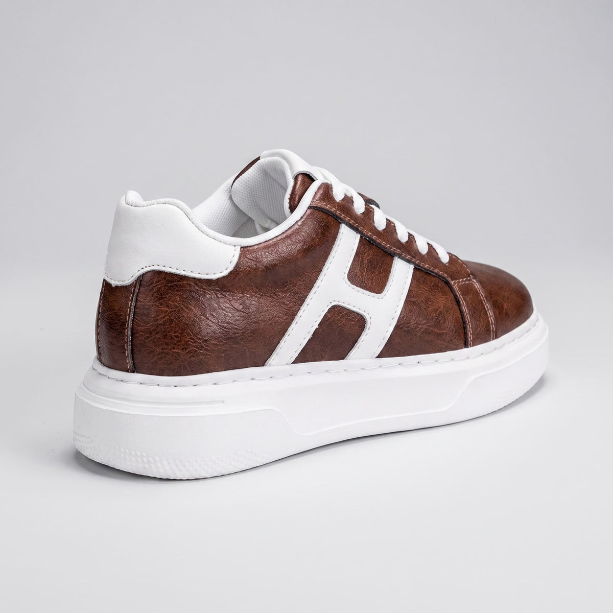 FORCIANO HAZEL brown women's platform sneaker in rear three-quarter view, showing the premium leather upper, white accents and raised white sole.