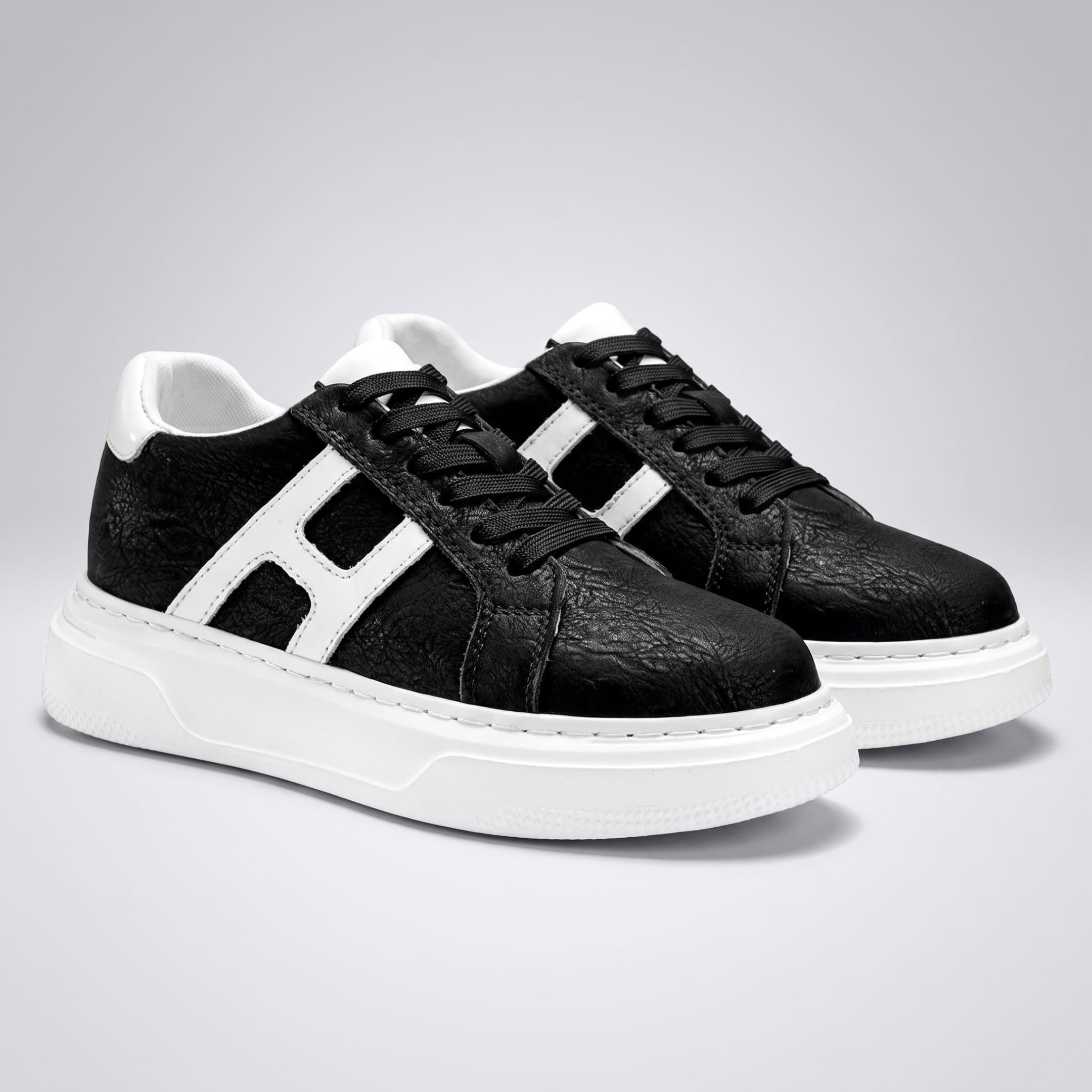 FORCIANO HERCULES black premium leather Height Increasing Sneakers shown as a pair from the front angle with white side accents and soles.