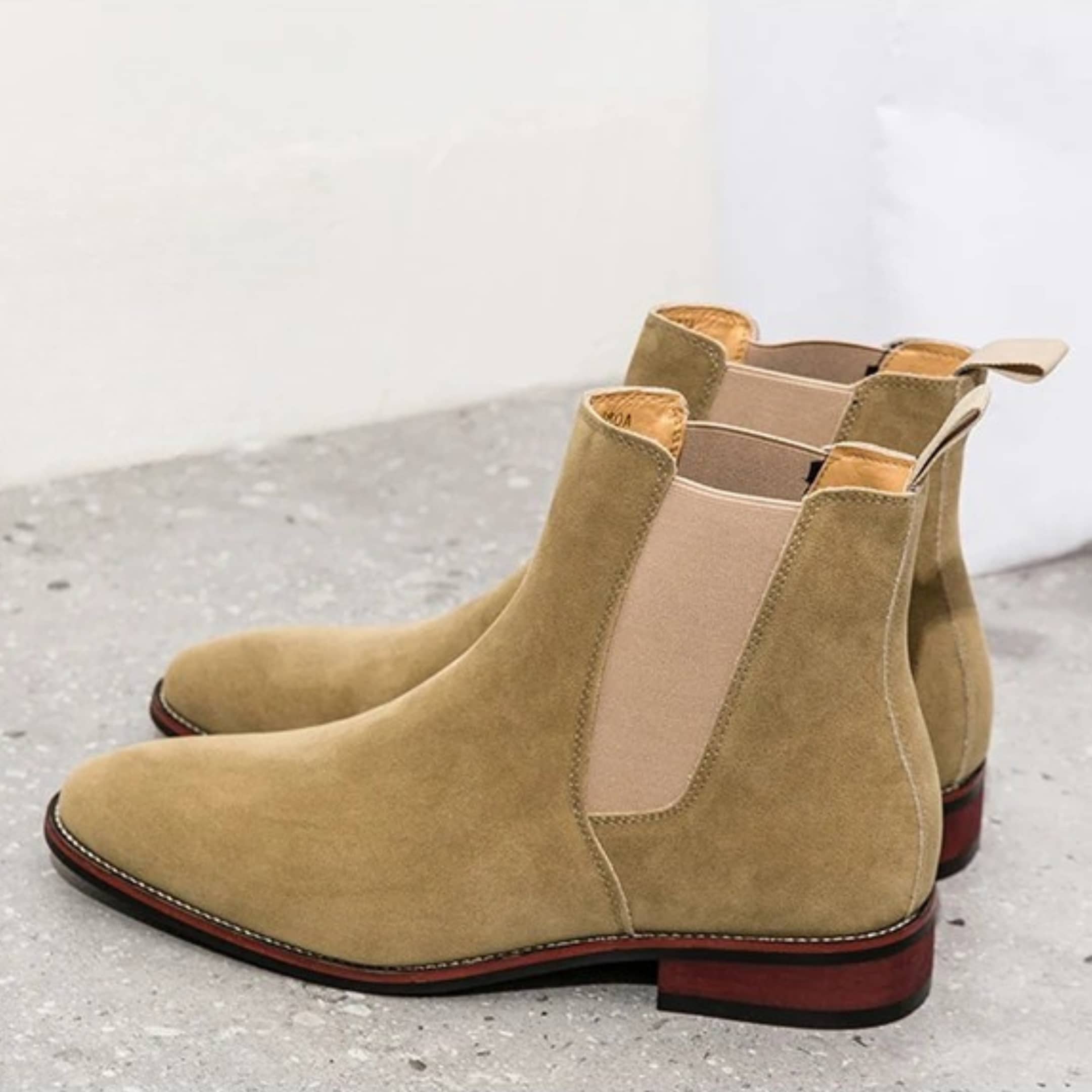 FORCIANO IVORY beige suede height increasing Chelsea boots shown as a pair from a rear-side angle.
