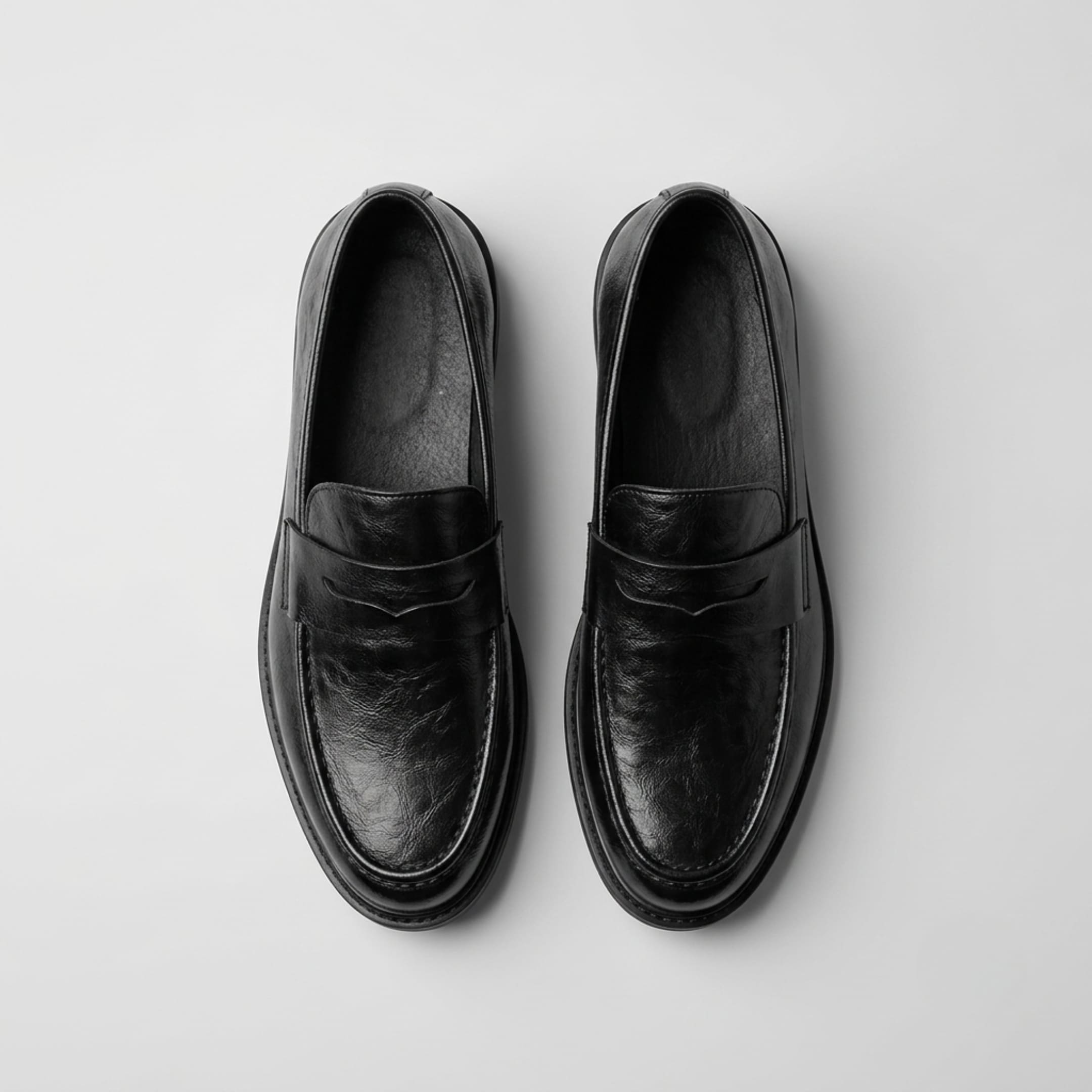 FORCIANO KINGSLEY black leather loafers shown as a pair from the top, highlighting the penny straps and slip-on openings.