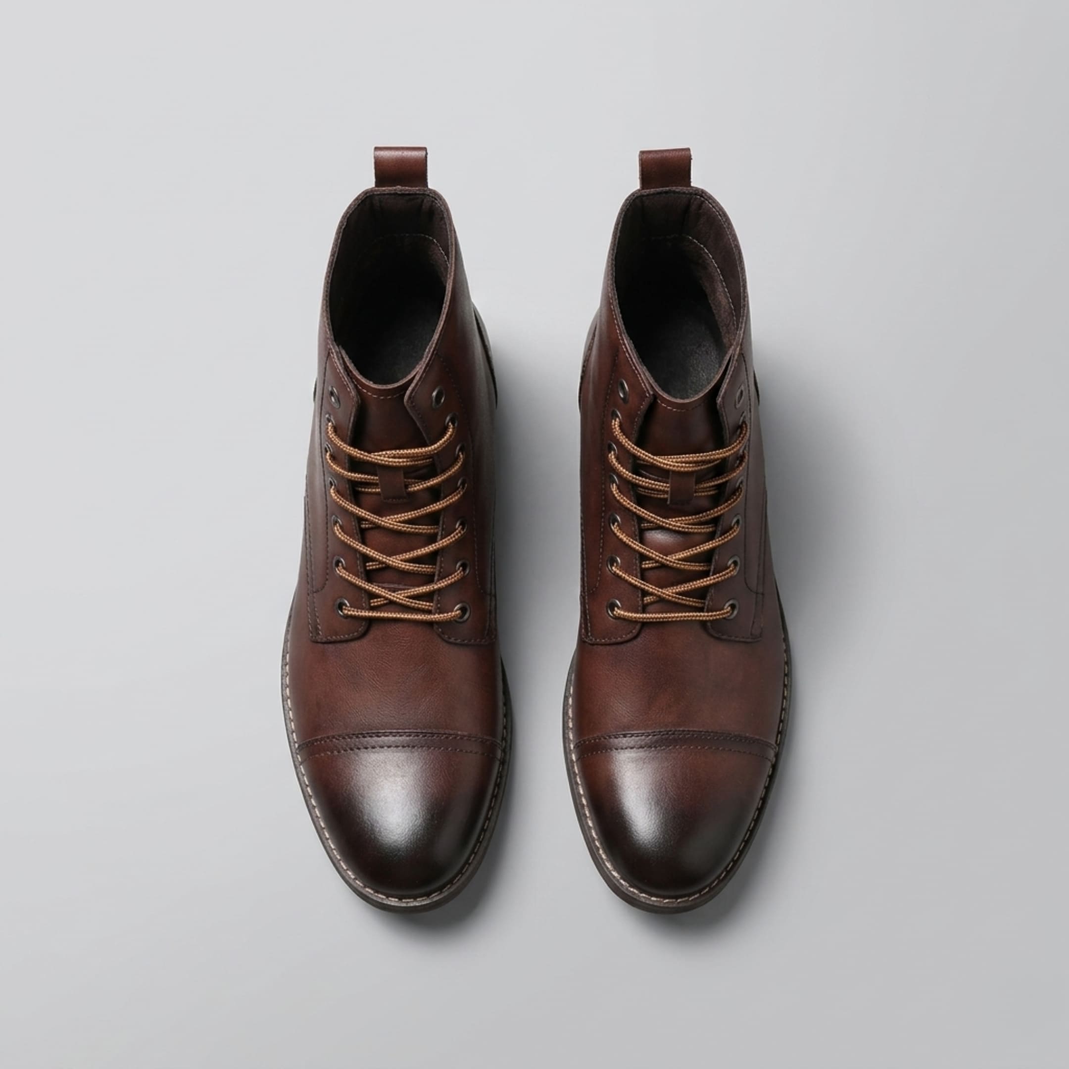 FORCIANO OUTLAW dark brown leather elevator boots shown from the top, highlighting the lace-up front, metal eyelets, and cap-toe design.