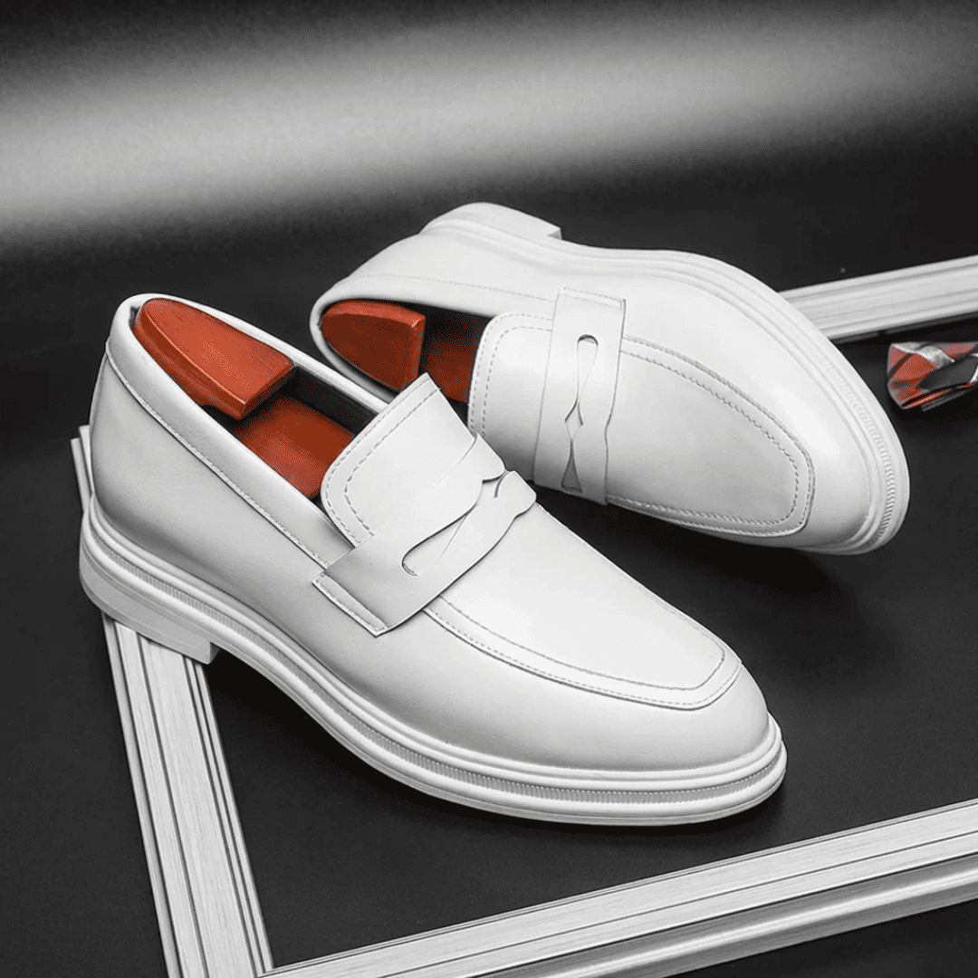 FORCIANO PANTHERA white leather elevator loafers arranged as a pair in diagonal three-quarter views on a dark display surface.