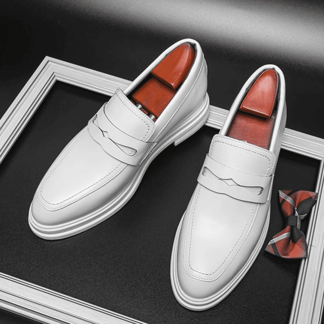FORCIANO PANTHERA white leather elevator loafers displayed as a pair from a high front angle with the interior shoe forms visible.