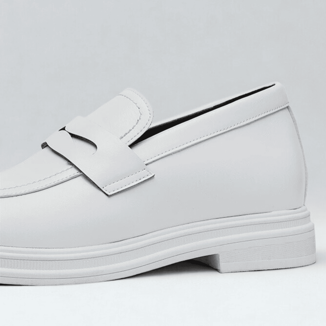 FORCIANO PANTHERA white leather elevator loafers shown in a close-up side detail highlighting the smooth upper, strap and white sole.