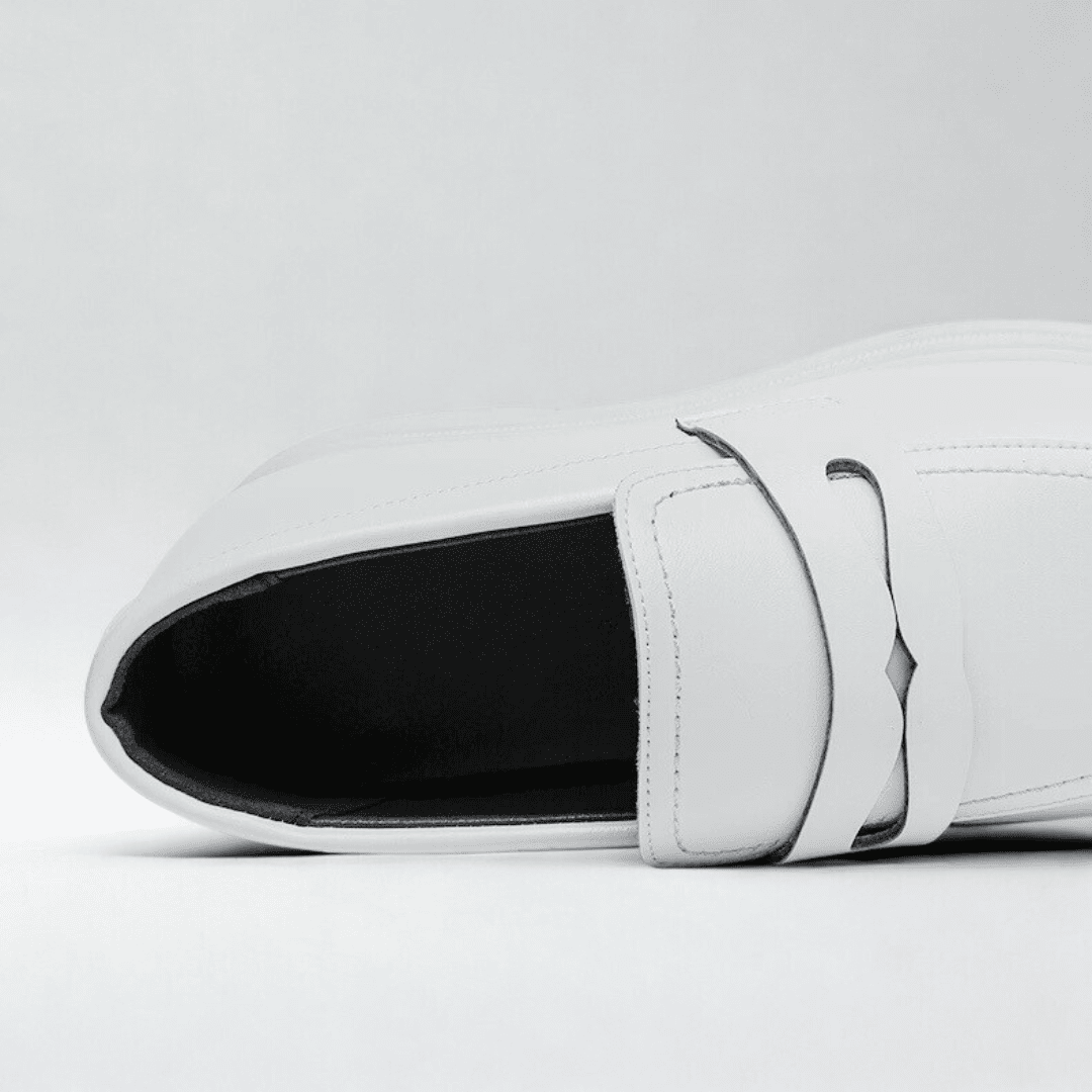 FORCIANO PANTHERA white leather elevator loafers shown in a close-up top view highlighting the opening, tongue and strap detail.