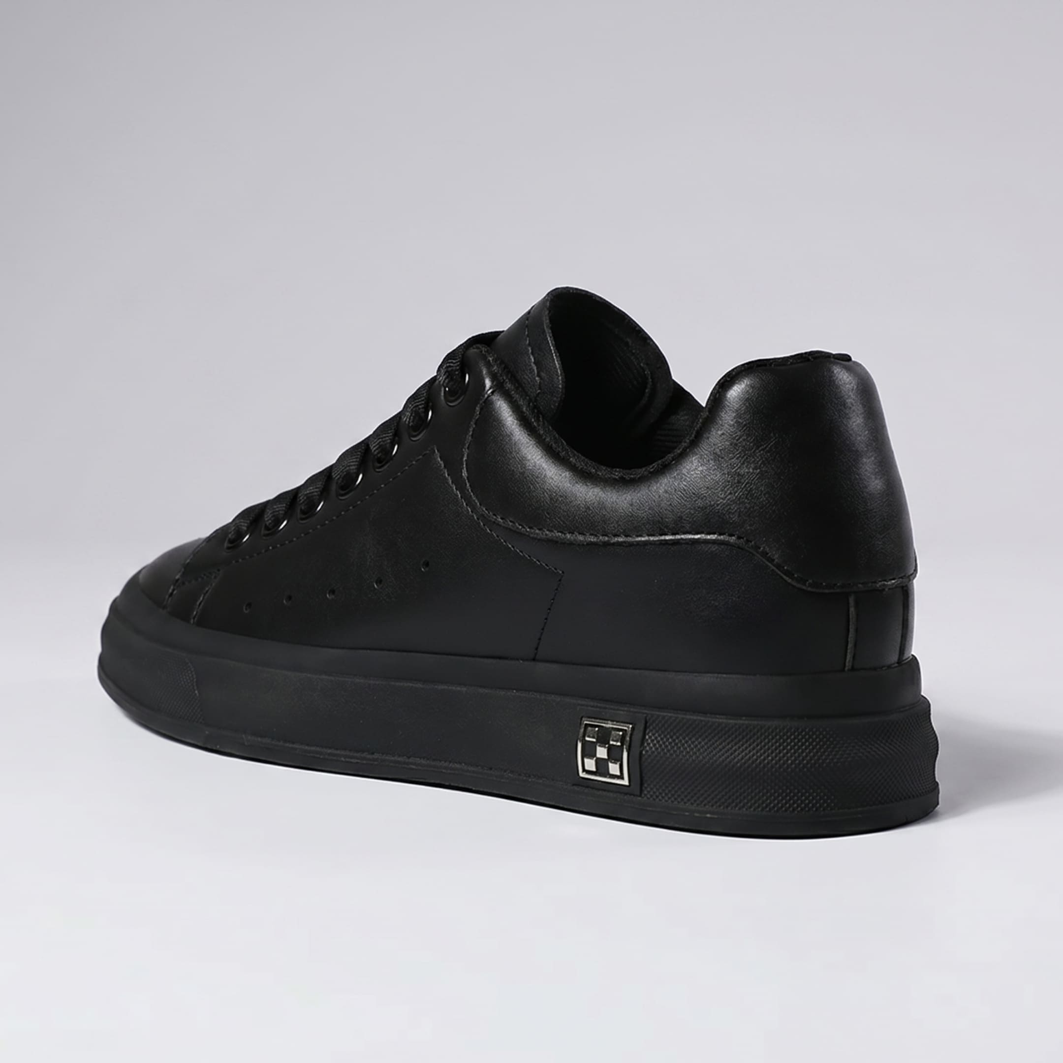 FORCIANO PORTOFINO black Elevator Sneaker with a premium leather upper, shown from a rear three-quarter side angle with the black sole visible.