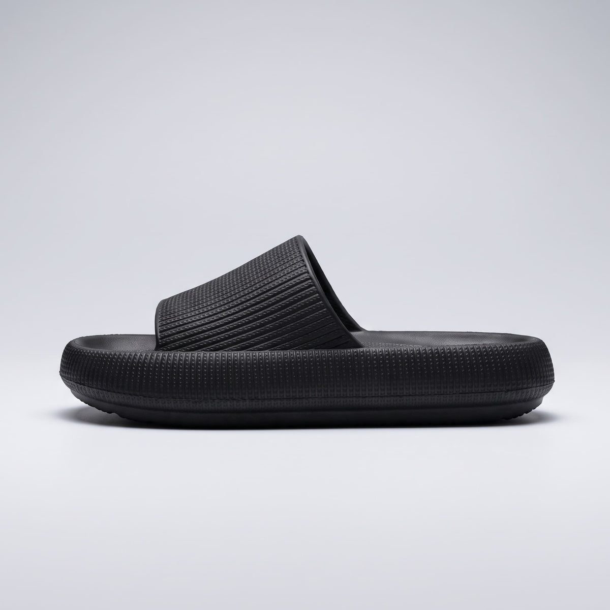 FORCIANO REESE black height increasing slippers for women shown from the side profile, highlighting the textured EVA upper and elevated sole shape.
