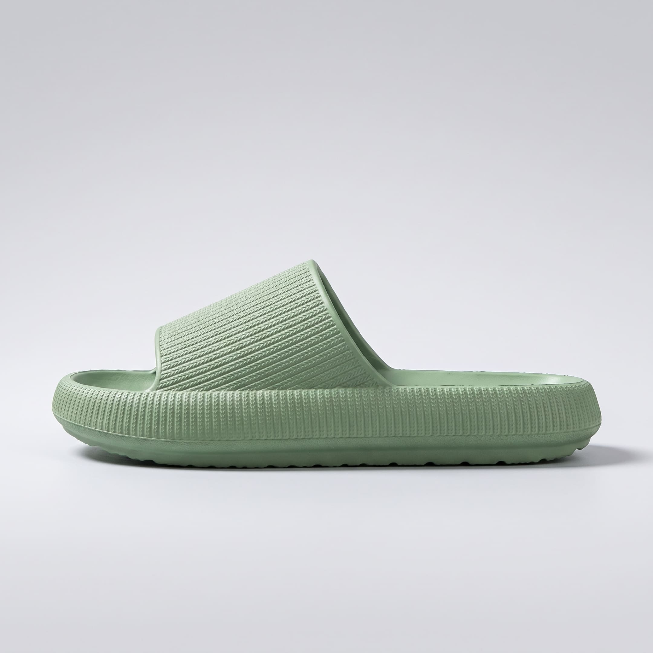 FORCIANO REESE green height increasing slippers for women shown in a full side profile with textured lightweight EVA upper and raised slide sole.