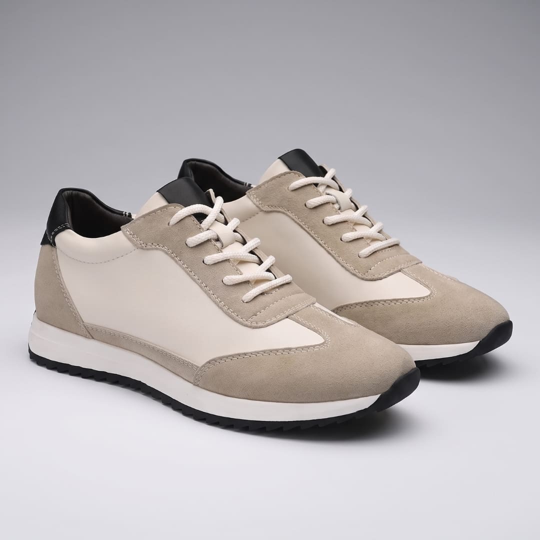 FORCIANO SALVATORE beige height increasing sneakers with cow suede uppers, black accents and white midsoles shown as a pair from a front three-quarter angle.