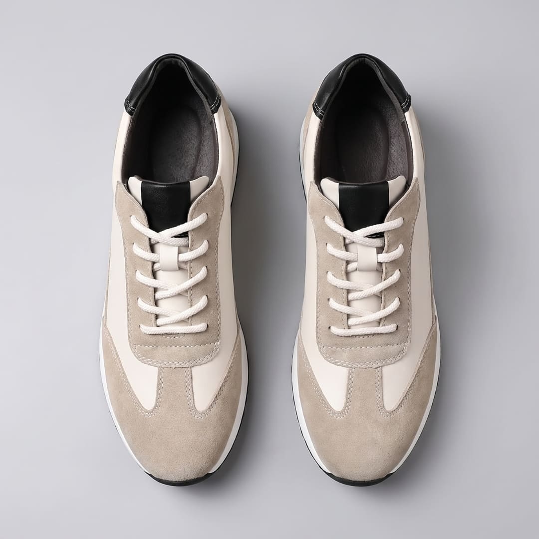 FORCIANO SALVATORE beige height increasing sneakers with cow suede uppers and black accents shown as a pair from the top with white laces.