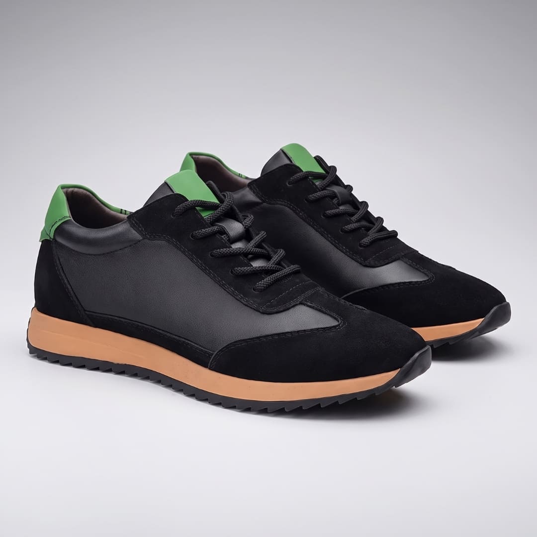 FORCIANO SALVATORE black height increasing sneakers with cow suede uppers, green accents and tan midsoles shown as a pair from the front angle.