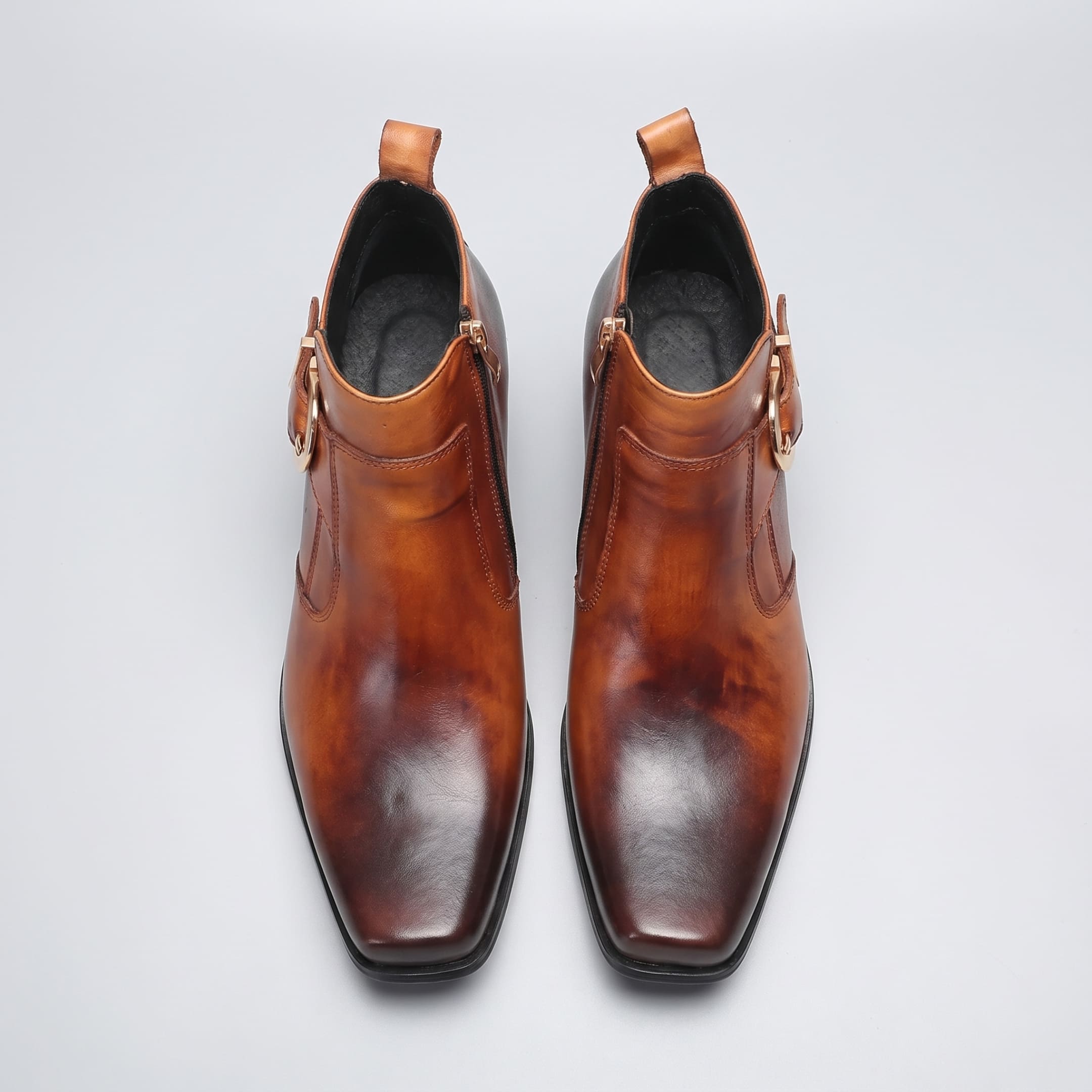 FORCIANO SCAROSSO brown genuine leather height increasing boot shown as a pair from above with square toes, side zippers and buckle details visible.