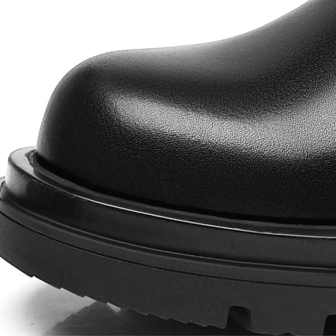 Close-up of the premium leather upper at the toe and sole edge of a FORCIANO SENTINEL black elevator Chelsea boot.