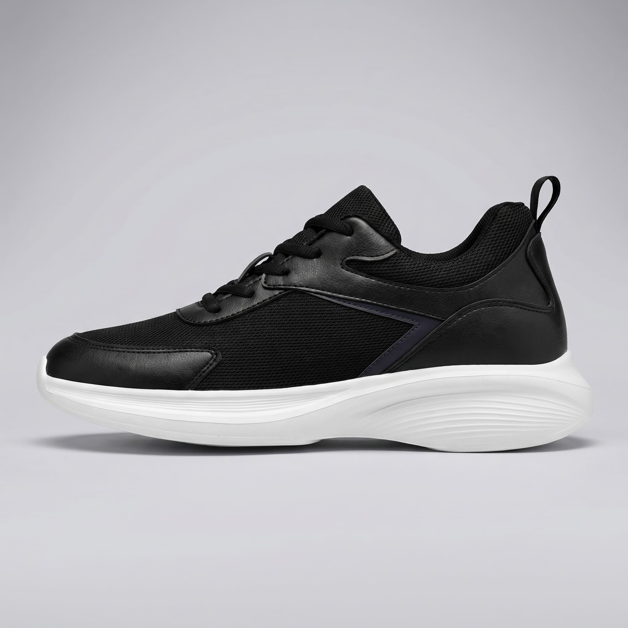 FORCIANO SUTTON black height increasing sneaker for women shown in clean side profile with Flyknit mesh upper, lace closure and white sculpted sole.
