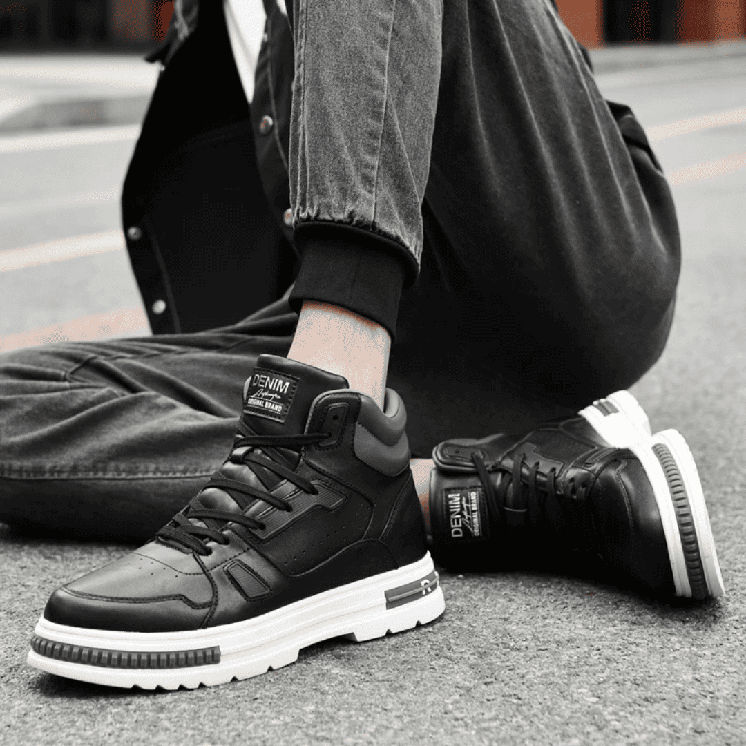 FORCIANO VADER black height increasing sneakers with white soles worn while seated in a casual setting.