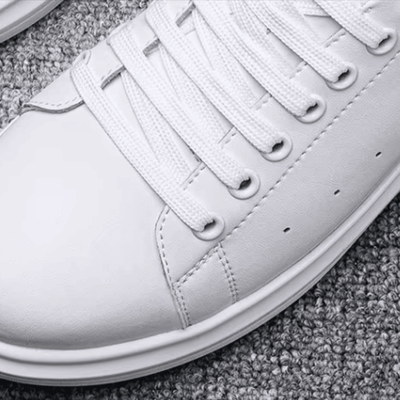 FORCIANO AURAS white elevator sneakers close-up showing the leather upper, laces and toe detail.