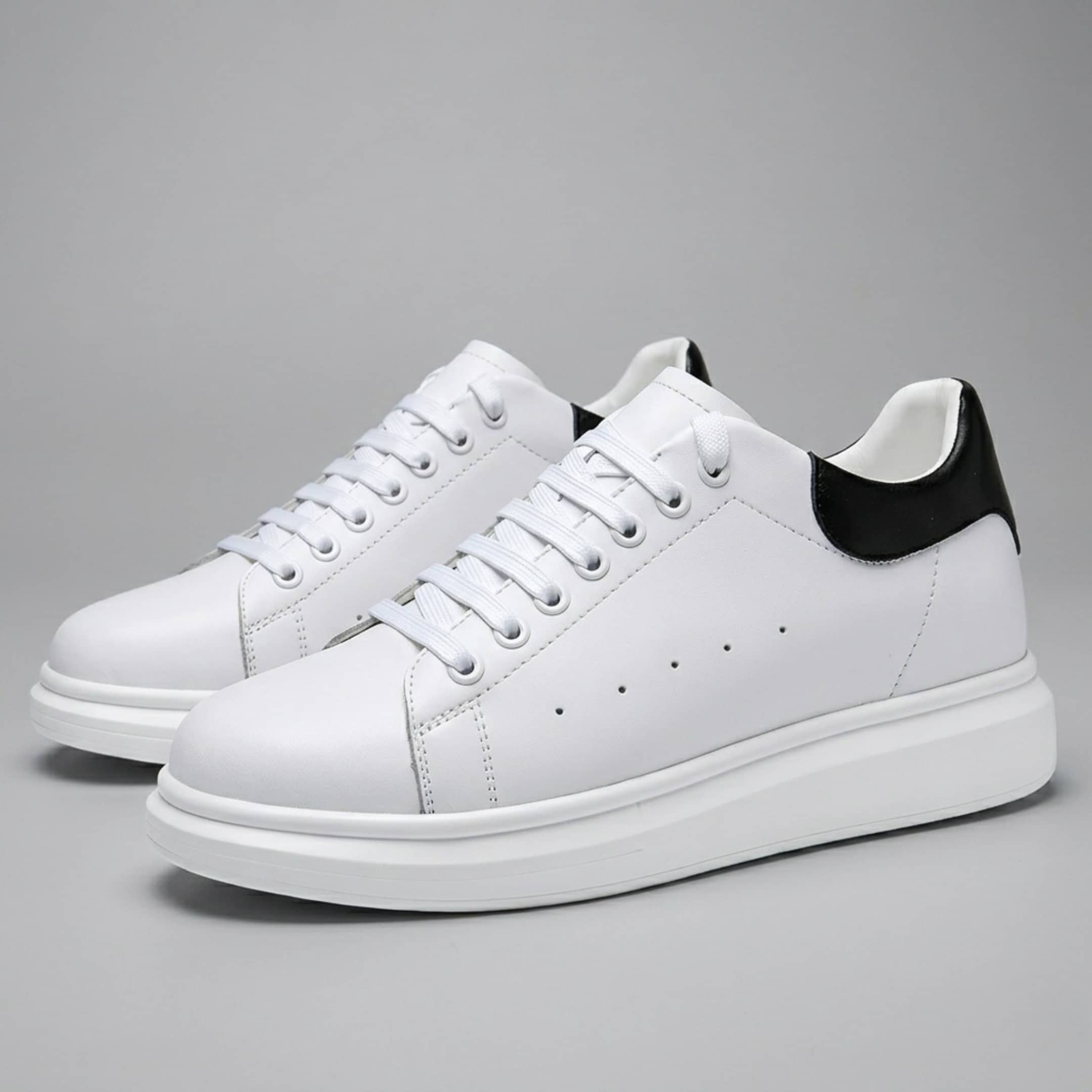 FORCIANO AURAS white elevator sneakers with leather upper, pair view on a grey background.