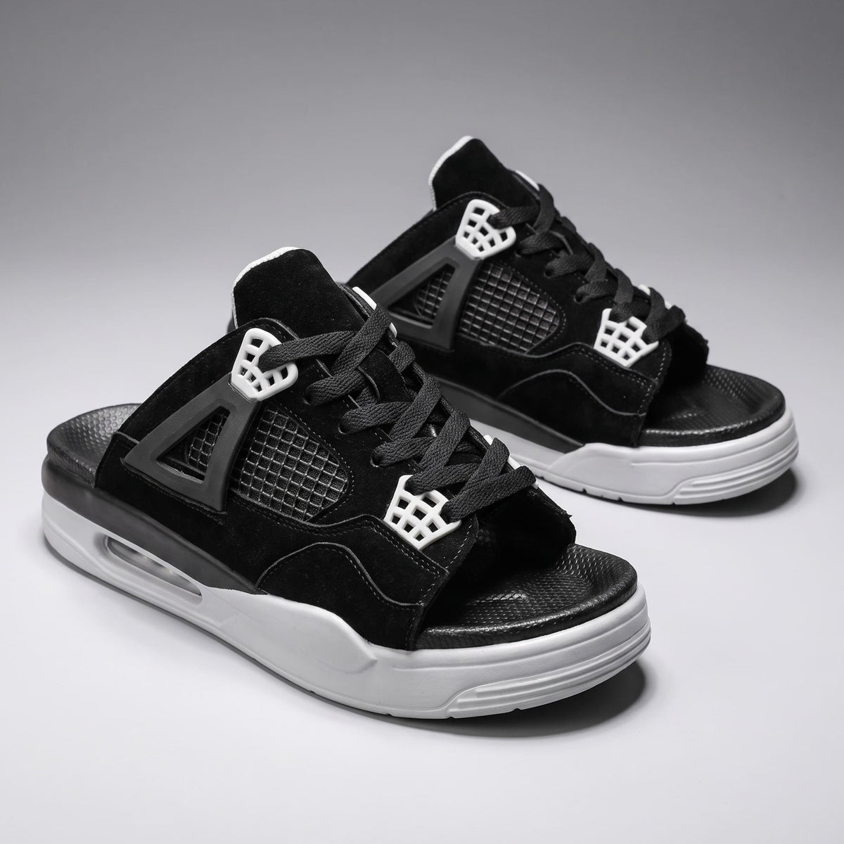 Pair of black FORCIANO AERO Height Increasing Slippers shown from a front three-quarter angle with white sole accents.