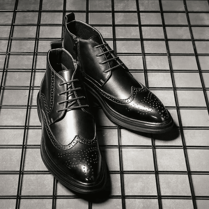 FORCIANO ALTIER black leather elevator boots arranged as a pair on a grid surface, showing front and angled views with brogue detailing.
