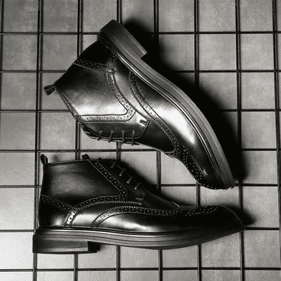 FORCIANO ALTIER black leather elevator boots shown from opposing side angles on a grid background, highlighting the ankle profile and decorative perforations.