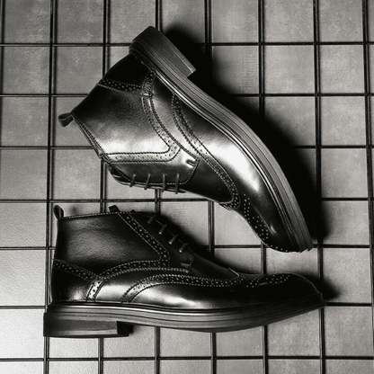 FORCIANO ALTIER black leather elevator boots shown from opposing side angles on a grid background, highlighting the ankle profile and decorative perforations.