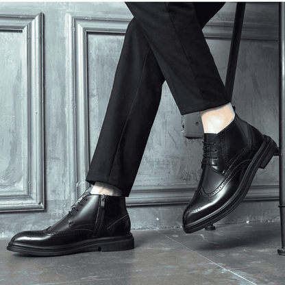FORCIANO ALTIER black leather elevator boots shown worn in a seated lifestyle pose, displaying side and front angles with brogue accents.