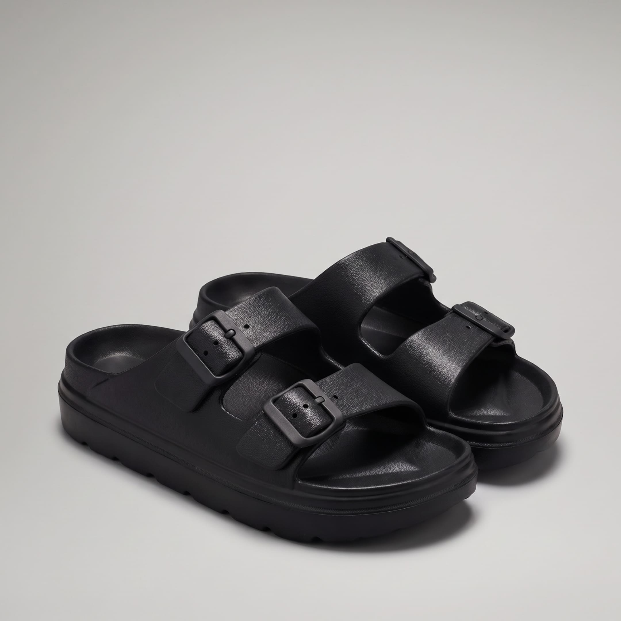 FORCIANO ARCHER black EVA sandals shown as a pair from a front three-quarter angle, with two buckle straps and the Height Increasing Shoes platform sole.