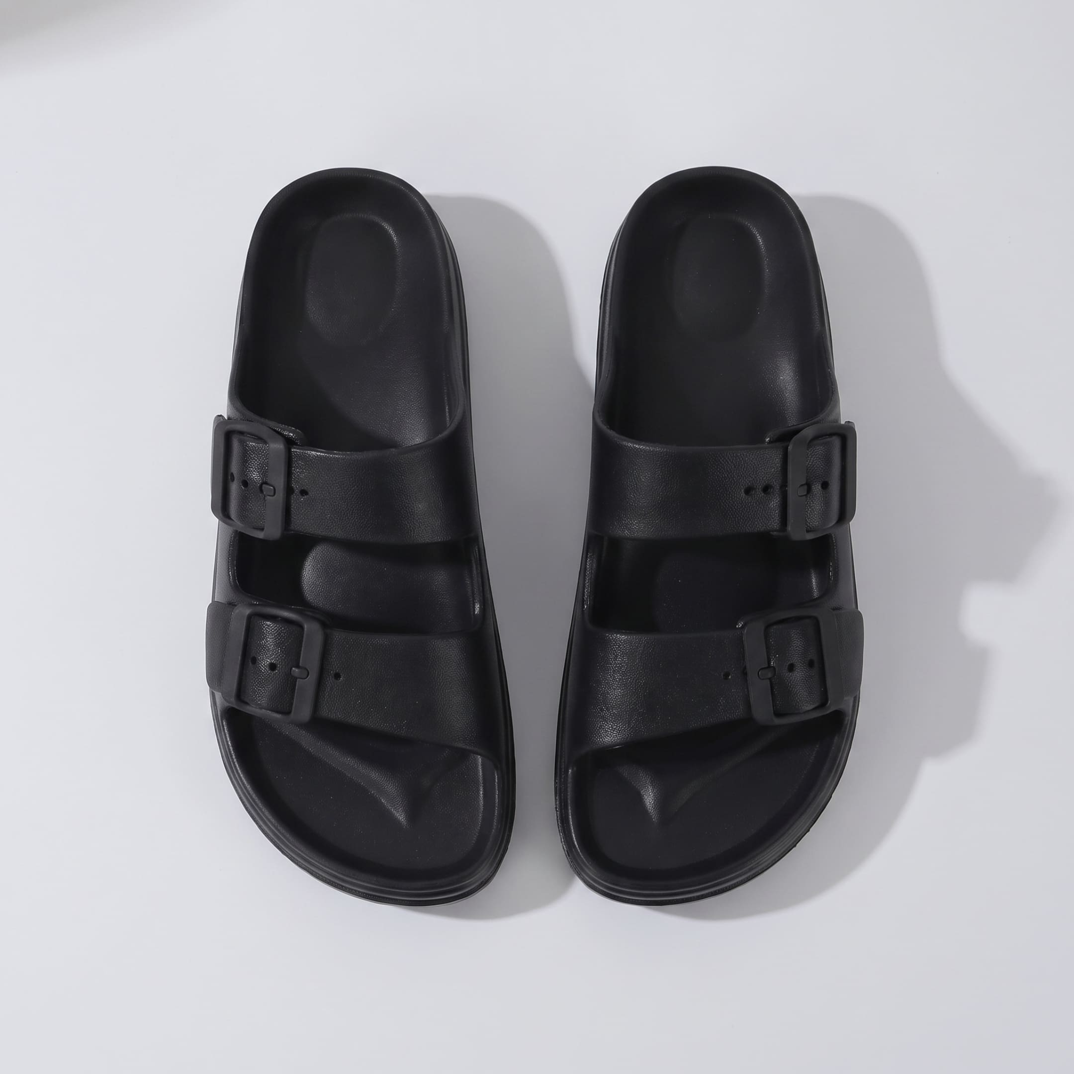Top view of a pair of FORCIANO ARCHER black EVA sandals, showing the two buckle straps and molded footbeds of the Height Increasing Shoes.