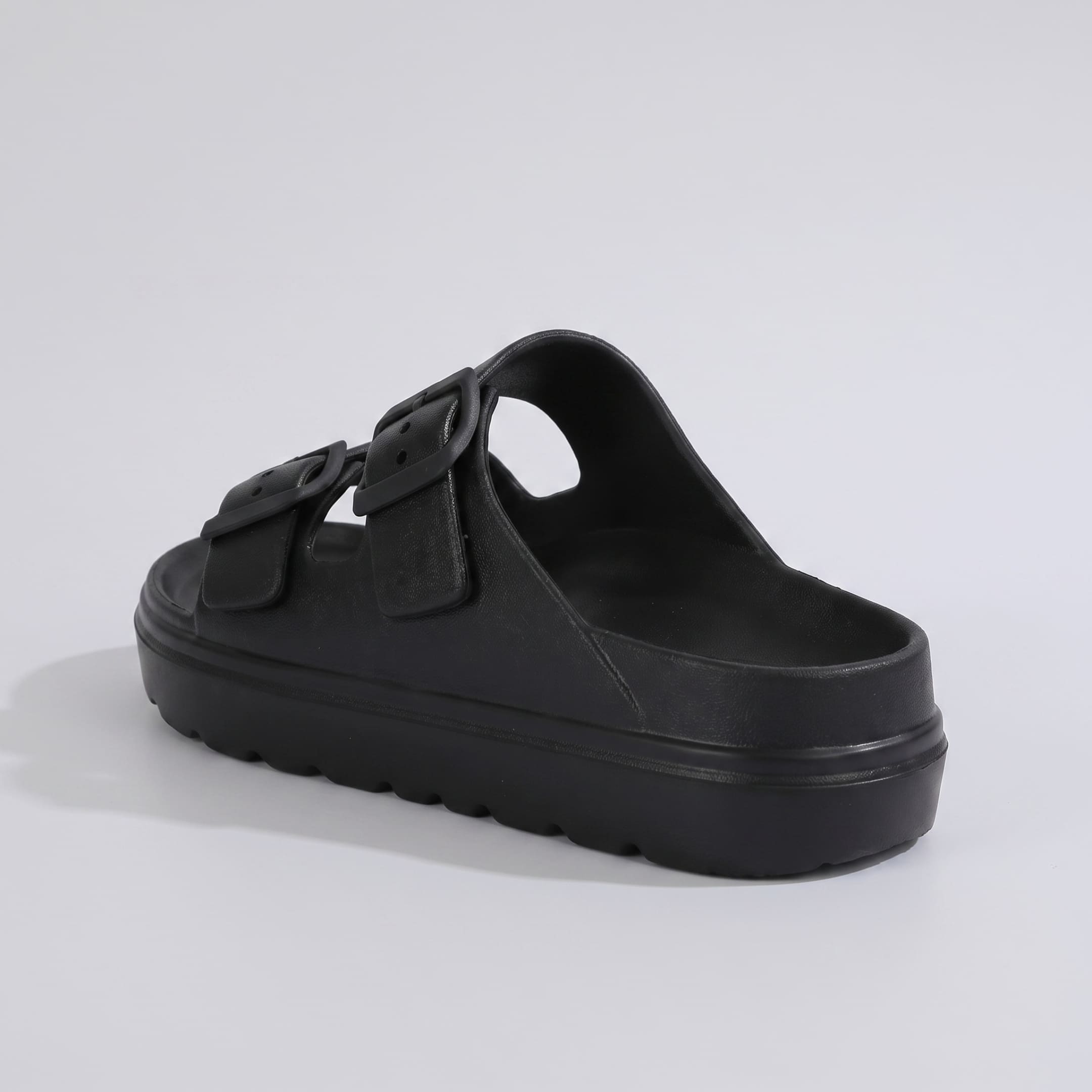 FORCIANO ARCHER black EVA sandal shown from a rear three-quarter angle, displaying the footbed, buckle straps and raised sole of the Height Increasing Shoes.