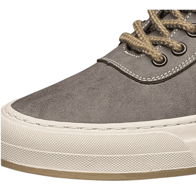FORCIANO ASCEND gray premium leather sneaker close-up showing the toe, tan laces, metal eyelets, stitching, and cream sole.