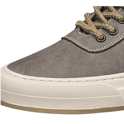 FORCIANO ASCEND gray premium leather sneaker close-up showing the toe, tan laces, metal eyelets, stitching, and cream sole.