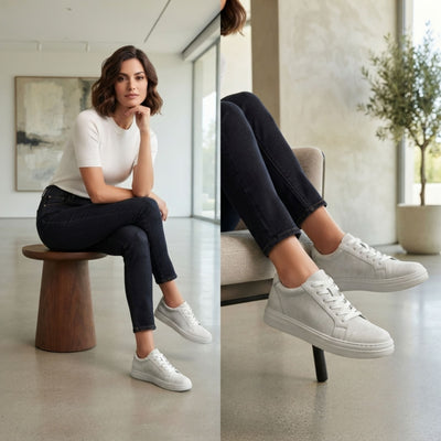 FORCIANO ATHENA white women's elevator sneakers worn by a woman in an indoor lifestyle setting, showing the premium leather lace-up design from seated angles.
