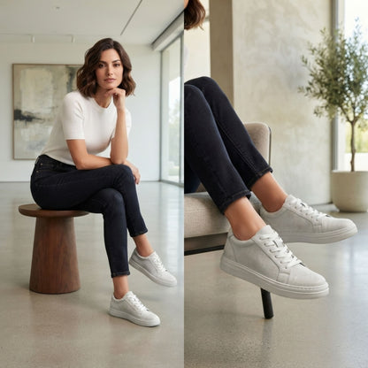 FORCIANO ATHENA white women's elevator sneakers worn by a woman in an indoor lifestyle setting, showing the premium leather lace-up design from seated angles.