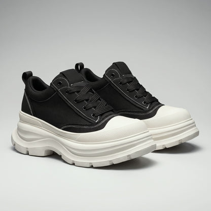 Pair of FORCIANO ATLAS Black elevator sneakers with White toe caps and sculpted soles, shown from a front three-quarter studio angle.